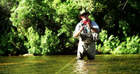 Man fly fishing in river alt