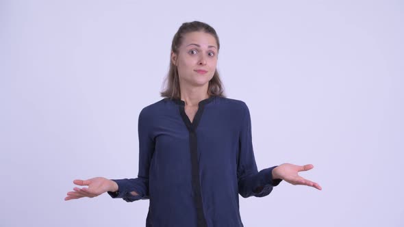 Confused Young Businesswoman Shrugging Shoulders alt