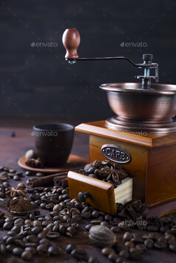Old vintage grinder with roasted coffee beans and grind coffee on stone background. - Stock Photo - Images