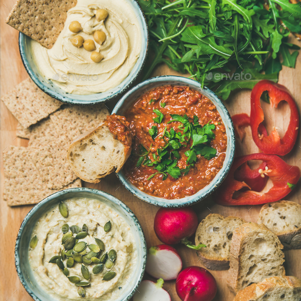 Flat-lay of Vegetarian dips hummus, babaganush, muhammara, square crop - Stock Photo - Images