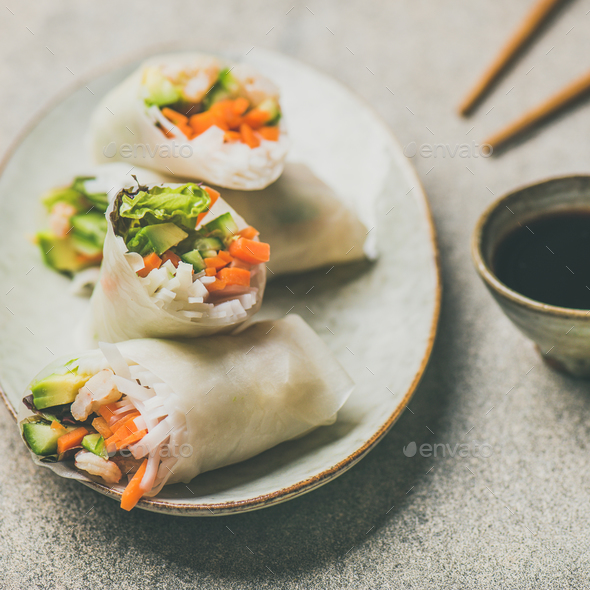 Shrimp and vegetable rice paper rolls, grey background, square crop - Stock Photo - Images