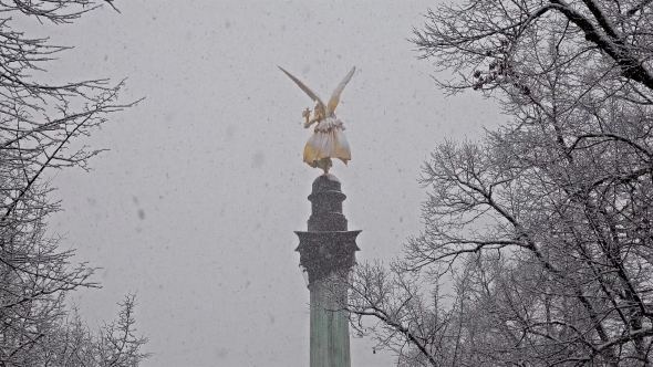 The Angel of Peace on the Top of Friedensengel Monument in Munich, Germany During the Snow Srorm alt