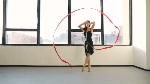 Brunette Young Women Dance Rhythmic Gymnastics, Modern with Red Ribbon in Black Sexy Dress in Front