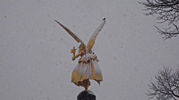 The Angel of Peace on the Top of Friedensengel Monument in Munich, Germany During the Snow Srorm alt