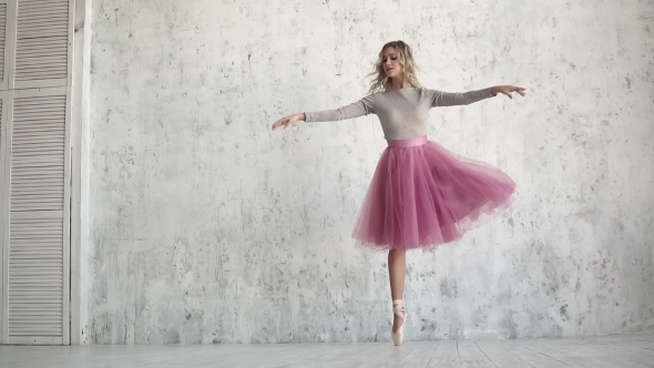 an Elegant Young Ballerina Is Dancing a Classical Ballet on the Background of a Huge Light Window alt