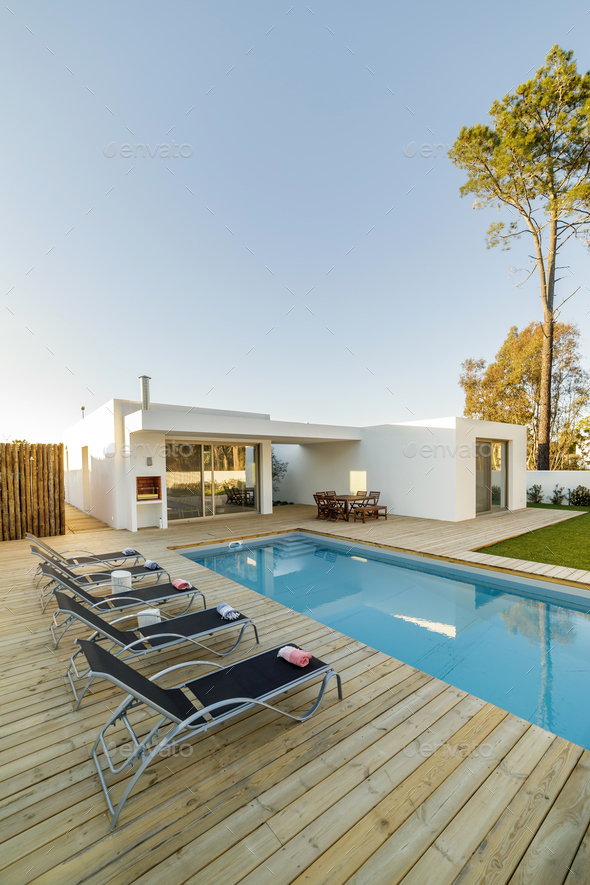 Modern house with garden swimming pool and wooden deck 