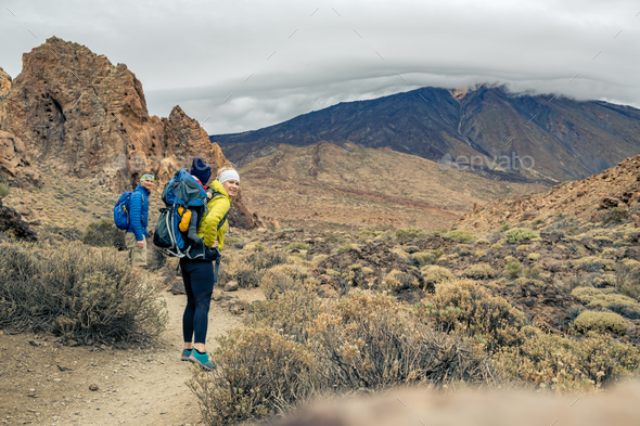 Family hiking with baby boy travelling in backpack - Stock Photo - Images