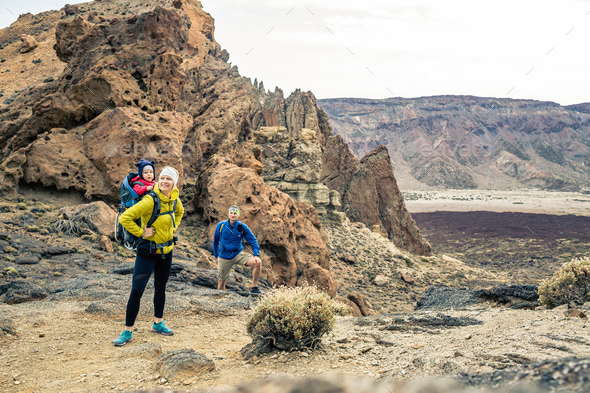Family hiking with baby boy travelling in backpack - Stock Photo - Images
