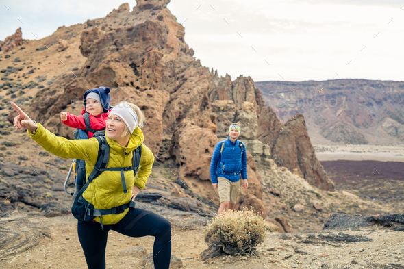 Couple hiking with baby boy travelling in backpack Stock Photo by blas