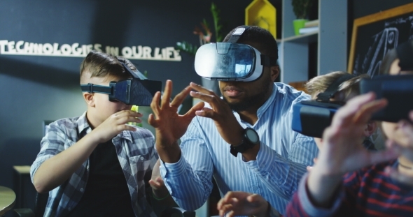 Children with Teacher Exploring Virtual World alt