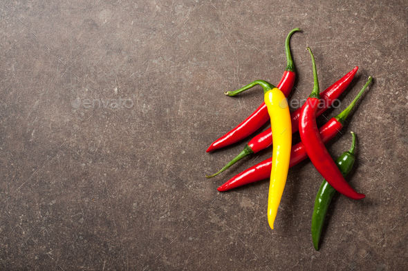 Colorful Chili Peppers On Stone Background Stock Photo By Ff-photo