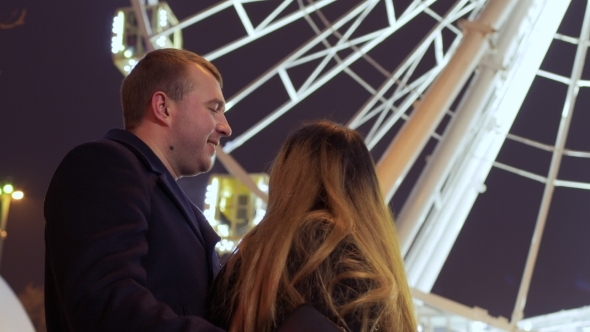 Young in Love People Are Kissing at Ferris Wheel Background alt