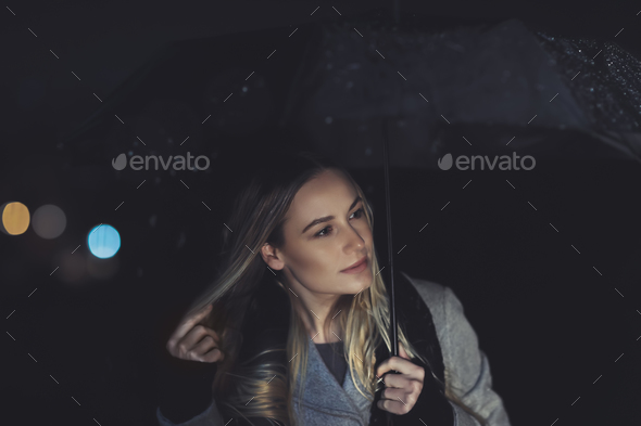 Pretty girl at rainy night outdoors - Stock Photo - Images