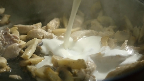 A Delicious Dish Is Cooked From Sliced Meat, Mushrooms and Poured White Sauce
