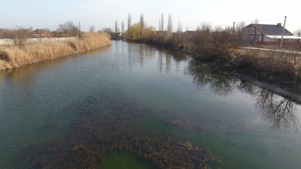 River Eric Current in the Village in the Spring Shallow River, Slowly Flowing in the Village.