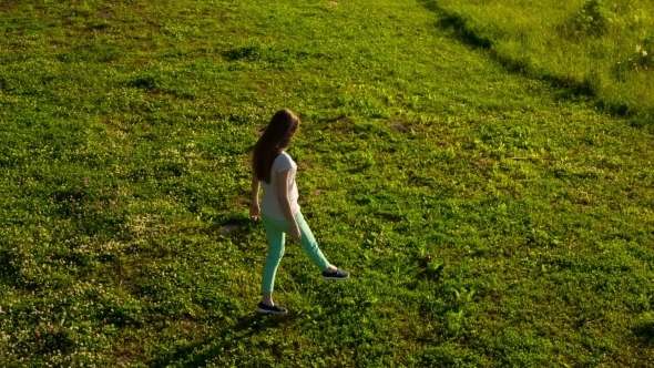 Sexy Pregnant Woman Walking on Green Grass