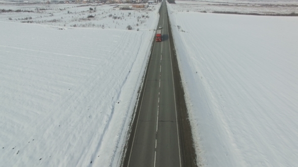 Aerial Shot of Cars and Trucks Driving on a Road on Winter Sunny Day