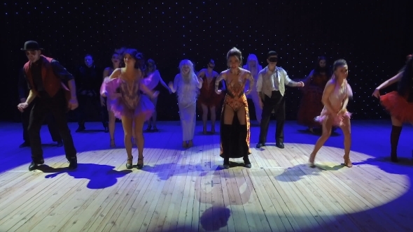 People in Beautiful Costumes and with Greasepaint Are Dancing in Modern Theatre alt