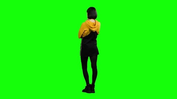 Teenager Stands with His Back To the Audience and Virtually Draws a Drawing. Green Screen alt