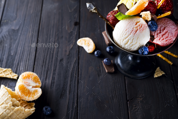 Bowl with ice cream with three different scoops of white, yellow, red colors and waffle cone - Stock Photo - Images