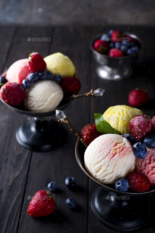 Bowl with ice cream with three different scoops of white, yellow and red colors, - Stock Photo - Images