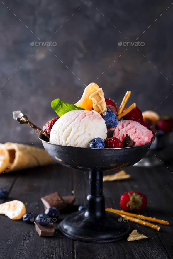 Bowl with ice cream with three different scoops of white, yellow, red colors and waffle cone - Stock Photo - Images