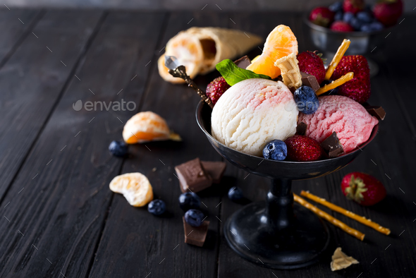 Bowl with ice cream with three different scoops of white, yellow, red colors and waffle cone - Stock Photo - Images