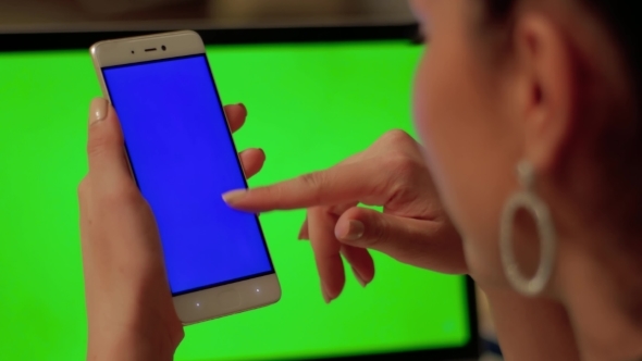 Girl Touches Phone with Blue Screen alt