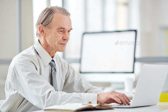 Aged office worker at office Aged office worker at office