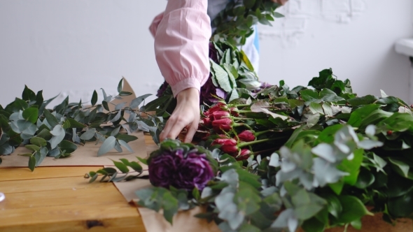 A Woman Florist Is Laying Flowers at Her Workplace
