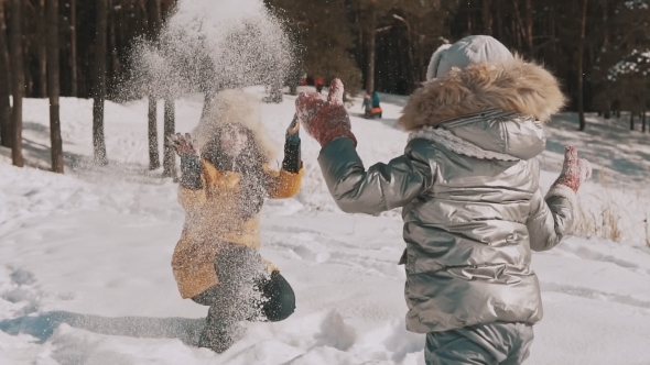 Mother Playing Snow with Little Daughter
