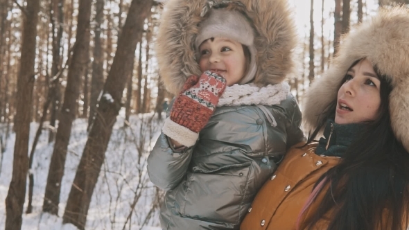 Mother and Daughter Having Fun in Cold Sunny Weather in Winter Park Outdoors
