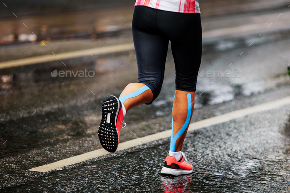 blue kinesio tape on calf muscle women runner Stock Photo by sportpoint74