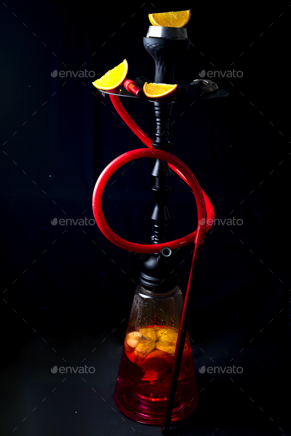Red hookah with orange slice on a black background - Stock Photo - Images
