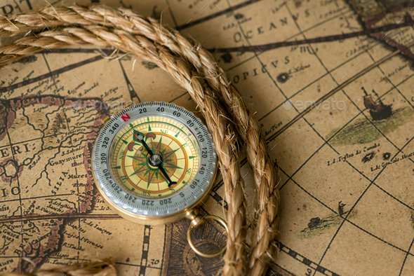 Old compass on vintage map with rope Stock Photo by byrdyak | PhotoDune