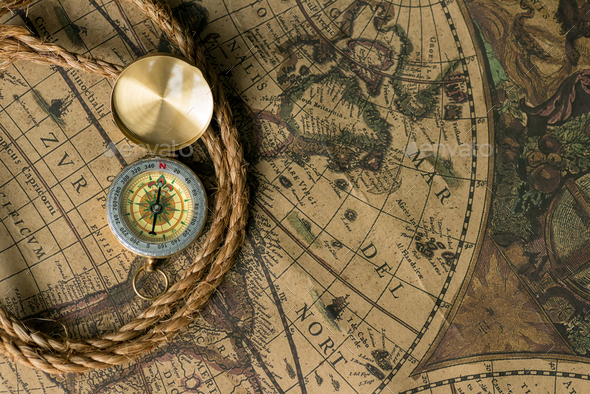 Old compass on vintage map with rope Stock Photo by byrdyak | PhotoDune