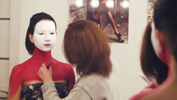 Makeup Artist Painting on the Model's Neck