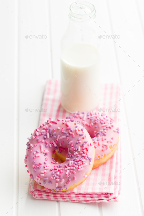 Pink donuts and milk bottle.