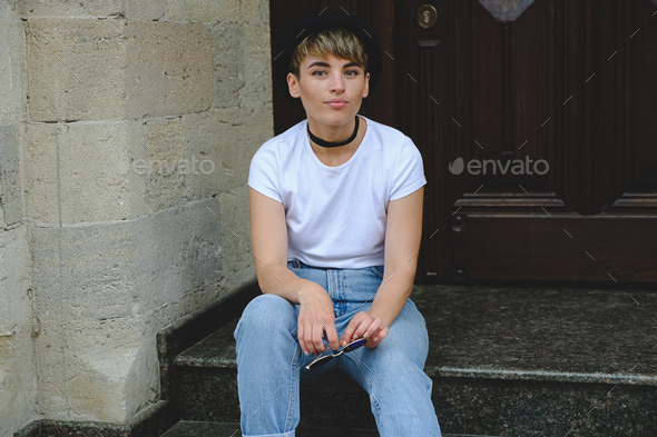 Beautiful young hipster woman posing sitting on stairs - Stock Photo - Images