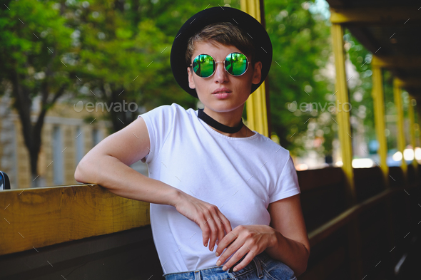 Young woman portrait wearing stylish hat and round glasses - Stock Photo - Images