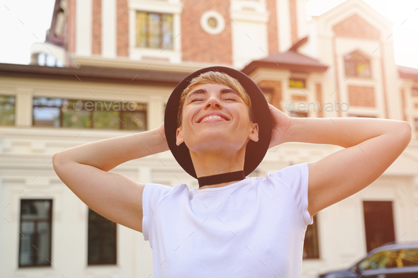 Woman enjoying a beautiful day in the city - Stock Photo - Images