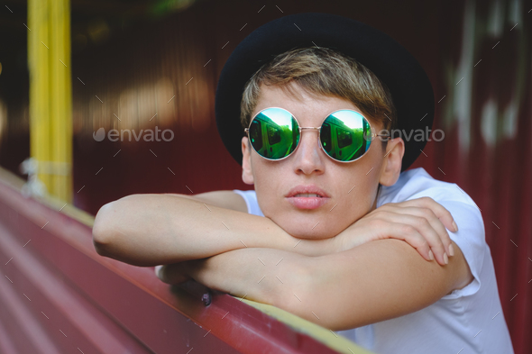 Young woman portrait wearing stylish hat and round glasses - Stock Photo - Images