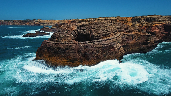 Aerial View of Sea Waves Run on the Rocky Coast alt