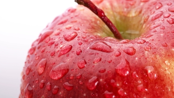 Beautiful Red Apple with Water Drops Rotates on White Background, alt