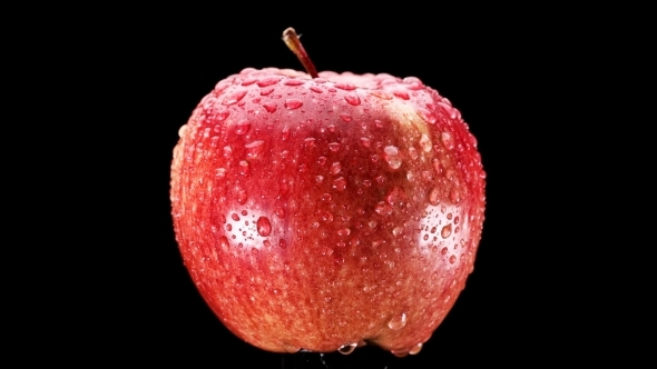 Beautiful Red Apple with Water Drops Rotates on Black Background, alt