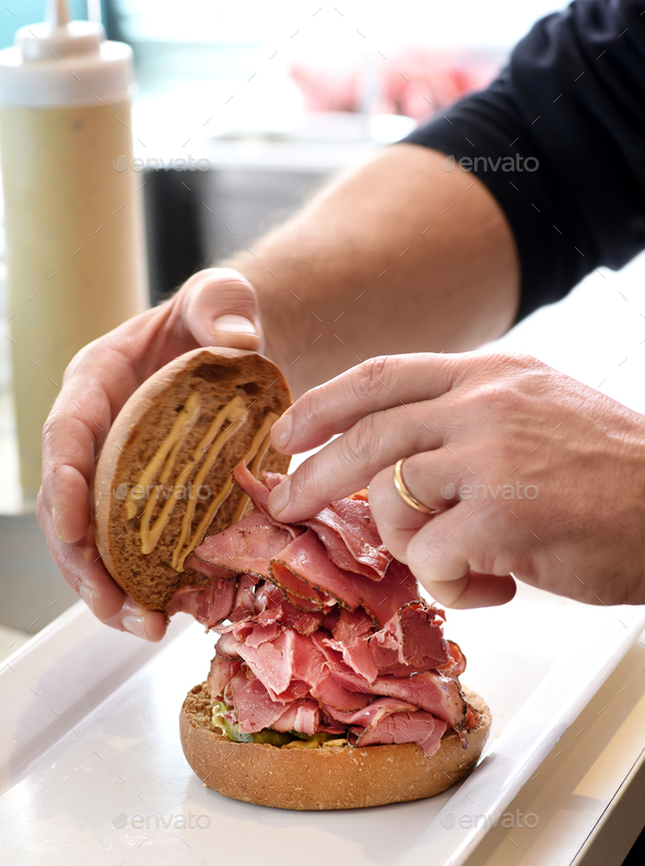 Chef preparing a pastrami sandwich - Stock Photo - Images