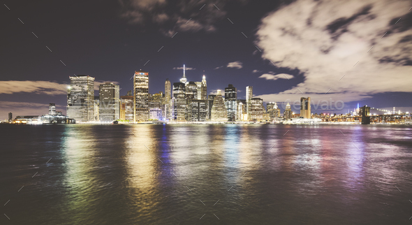 Wide angle picture of New York skyline at night.