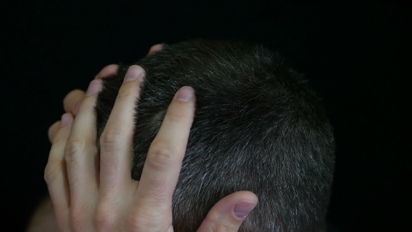 A Man Touches His Hair on His Head, Against a Black Background - 2. The Hair of a Man Is Gray. alt