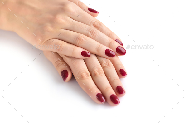 Closeup of hands of a young woman with red manicure on nails aga - Stock Photo - Images