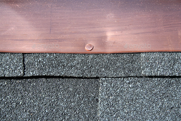 Black asphalt roofing shingles with copper flashing - Stock Photo - Images